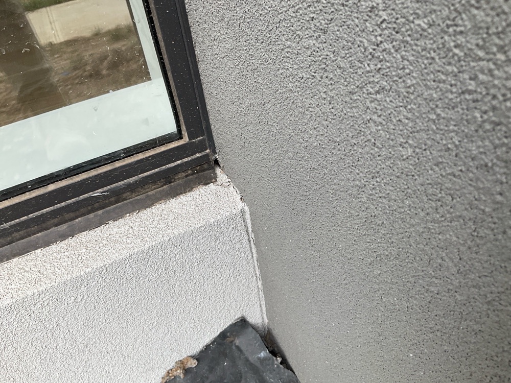 Excessive gap between window and cladding left unsealed against weather, found during a pre-handover inspection in Clyde