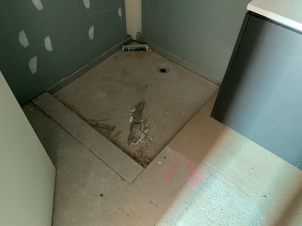 Shower hob and floor grading not yet formed, so waterproofing cannot be signed off, found during a fixing and waterproofing inspection in Clyde