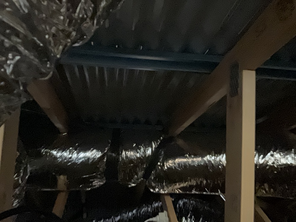 Sarking missing under the metal roof, leaving no second barrier against wind driven rain, found during a lock-up inspection in Clyde